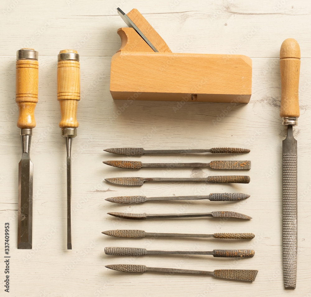 ordered carpenter tools on white wooden board