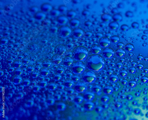 Lots of clean round water drops on blue background