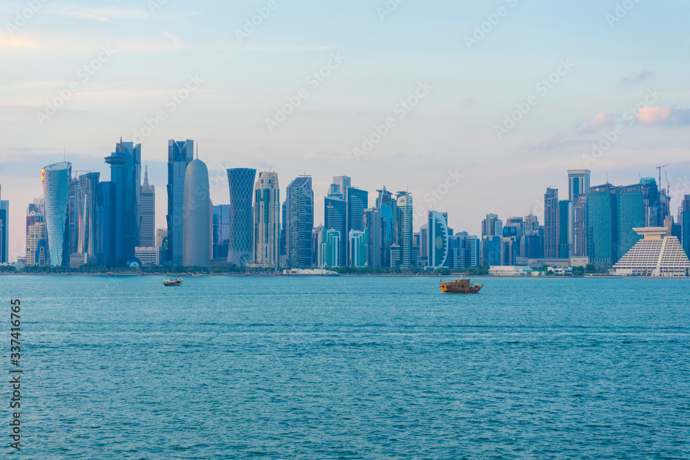 View of modern skyscrapers and bay at twilight in Doha, Qatar
