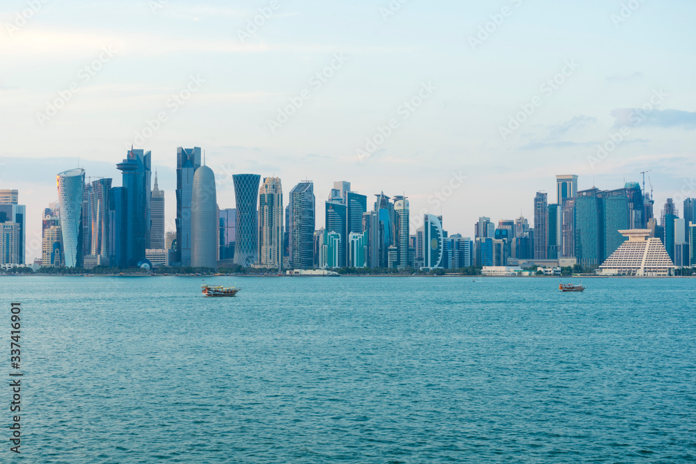 Fototapeta premium View of modern skyscrapers and bay at twilight in Doha, Qatar