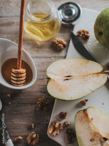 Fototapeta Naklejka Na Ścianę i Meble -  pears, honey in a jar and nuts on a wooden table