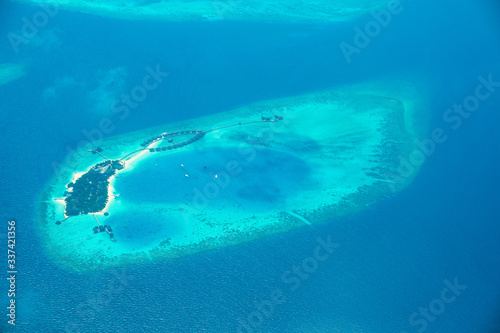 Aerial view from Waterplane of small Island at Maldives.