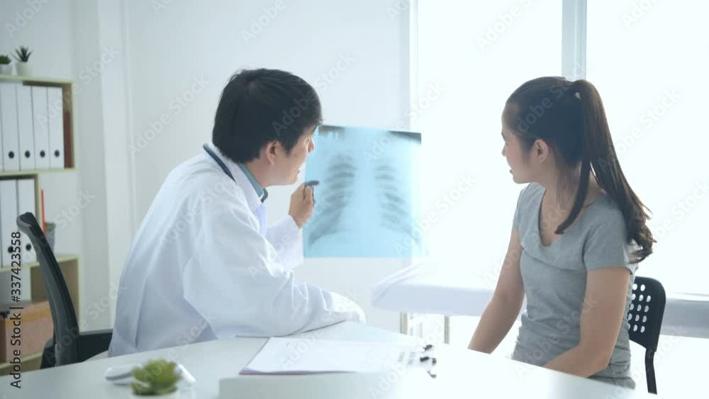 Medical concepts. The doctor is explaining the x-ray to the patient in the hospital. 4k Resolution. Medical concepts. The doctor is explaining the x-ray to the patient in the hospital. 4k Resolution.