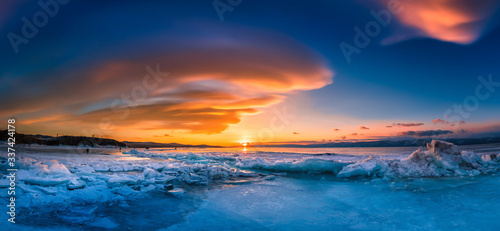 Sunset sky with natural breaking ice over frozen water on Lake Baikal, Siberia, Russia. © nuttawutnuy