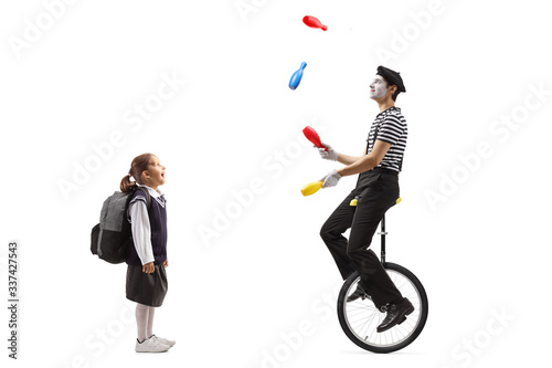 Schoolgirl watching a clown juggling and riding a unicycle © Ljupco Smokovski