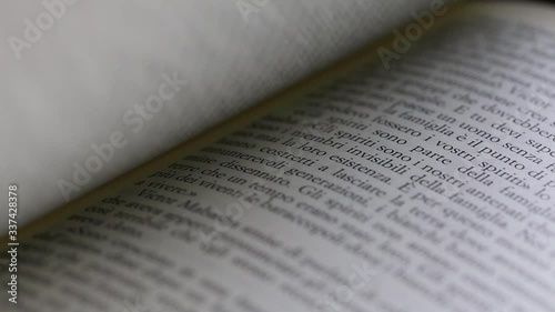 Close up macro of man's hand turning pages of a book