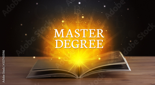 MASTER DEGREE inscription coming out from an open book, educational concept photo