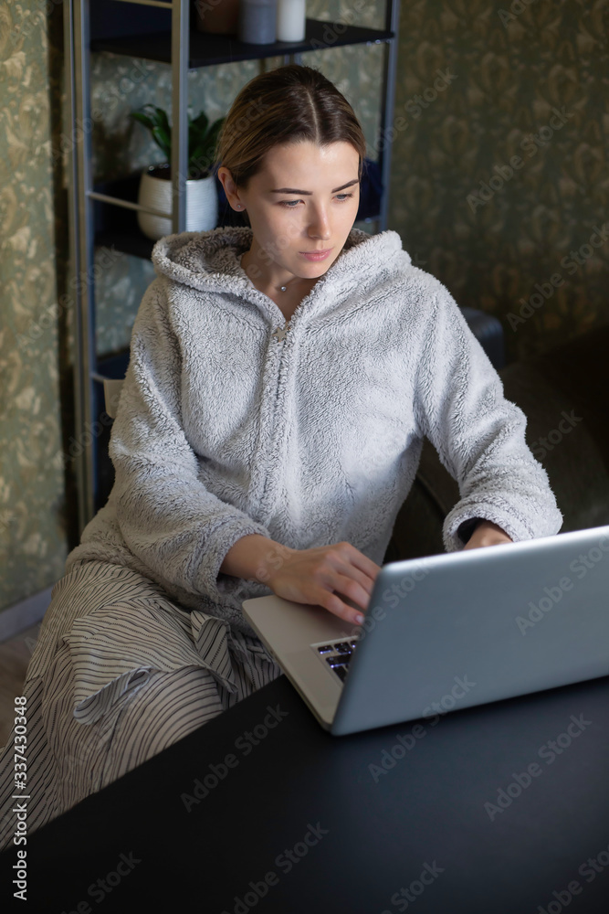young woman working on laptop. beautiful girl is working on a distance. beautiful girl works at home during quarantine. Covid-19. Covid-20. young woman working on laptop. beautiful girl is working on a distance. beautiful girl works at home during quarantine. Covid-19. Covid-20.