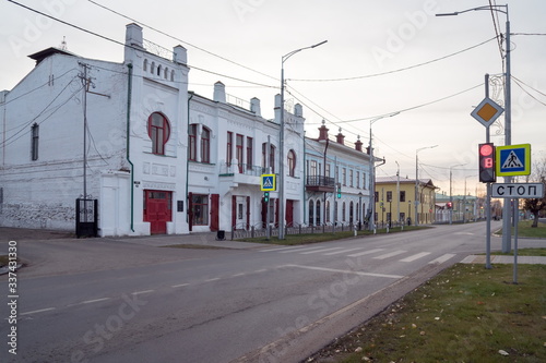 Central street with a pedestrian crossing and a view of the historical house (1909) of the estate of the merchant Borodkin. Yeniseisk. Krasnoyarsk region. Russia.