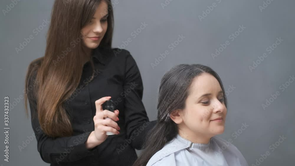 Beautiful girl fixing hair in beauty salon Beautiful girl fixing hair in beauty salon