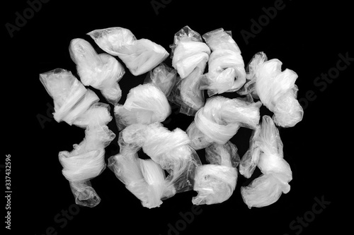 empty crumpled plastic bags on a dark background. The concept of consumption and environmental pollution. photo