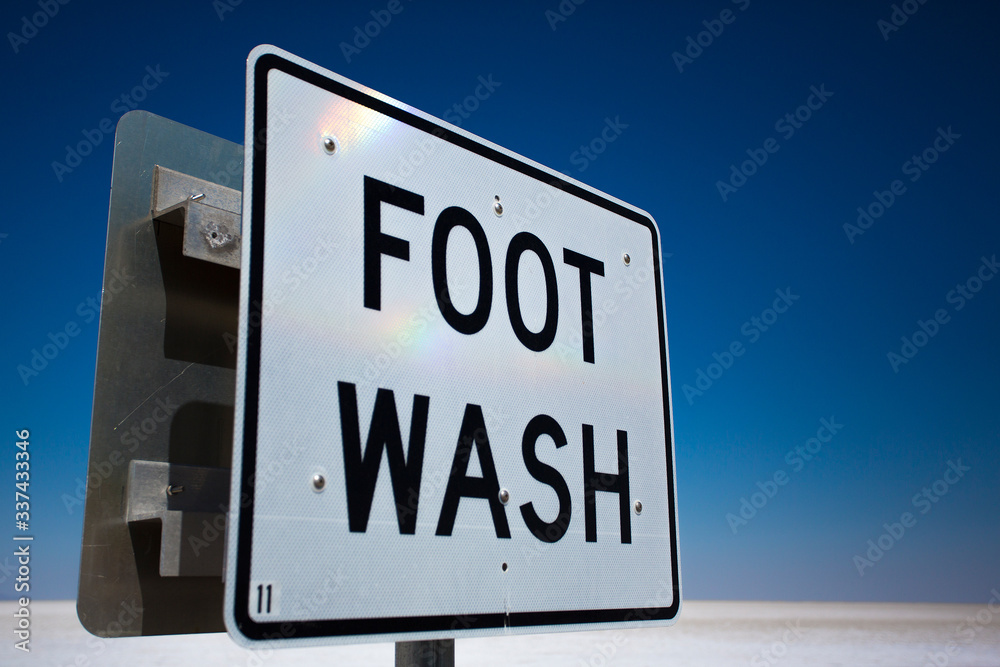 Foot Wash sign at Bonneville Salt Lake Flats against a blue sky Foot Wash sign at Bonneville Salt Lake Flats against a blue sky