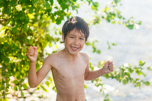 boys in blue swimming trunks having fun in the lake in summer