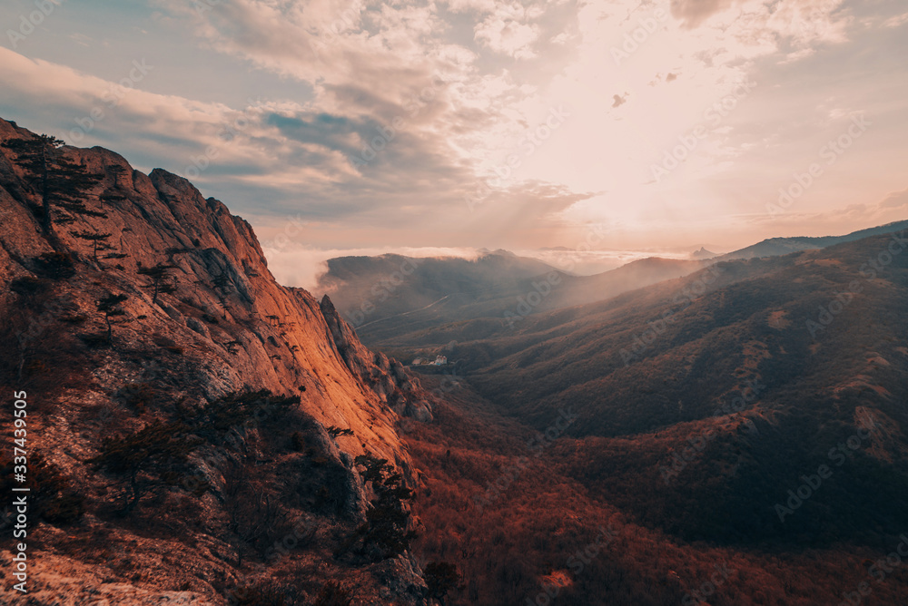 Fototapeta premium Mountains in the fog at sunset