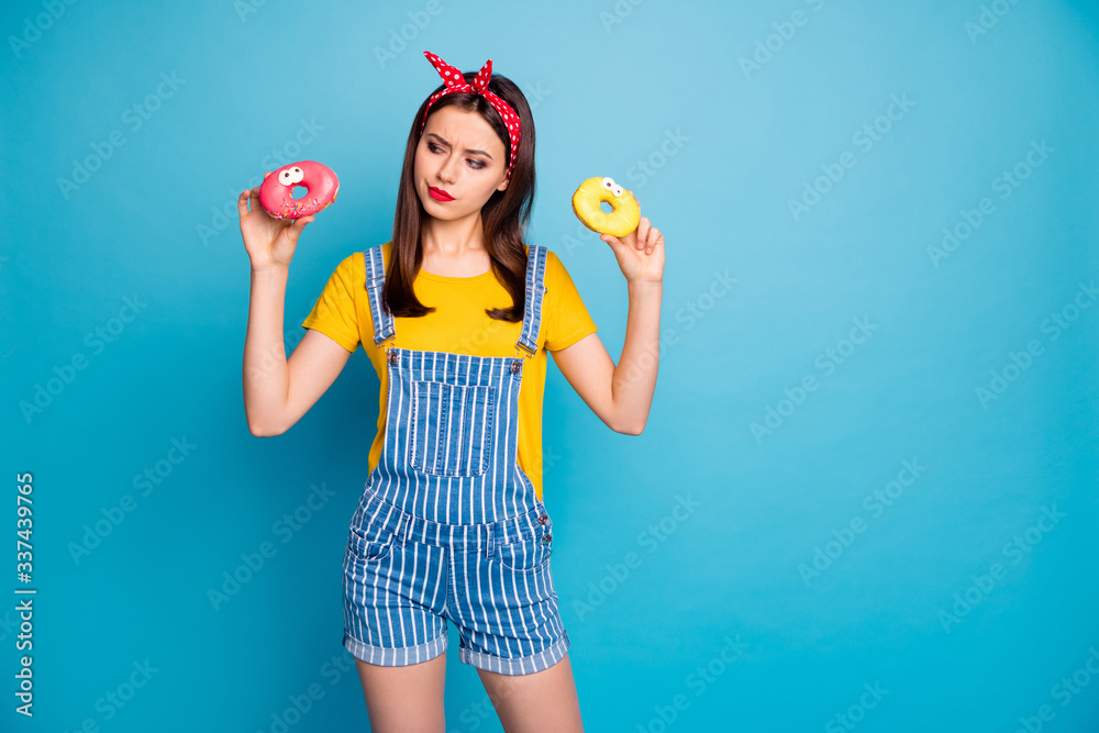 Portrait of her she nice attractive lovely glamorous pensive minded girl holding in hands two macaron isolated on bright vivid shine vibrant blue green teal turquoise color background Portrait of her she nice attractive lovely glamorous pensive minded girl holding in hands two macaron isolated on bright vivid shine vibrant blue green teal turquoise color background