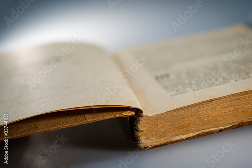 pages of an open old book lying on a table. Web banner.