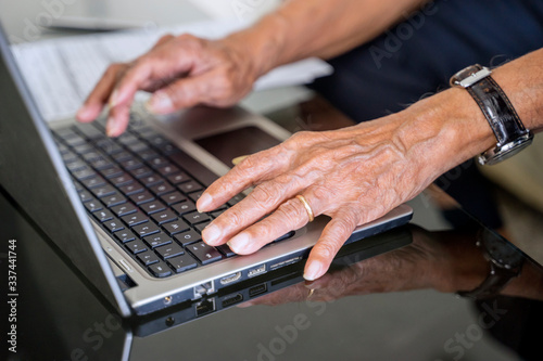 Senior man hand working with laptop on table