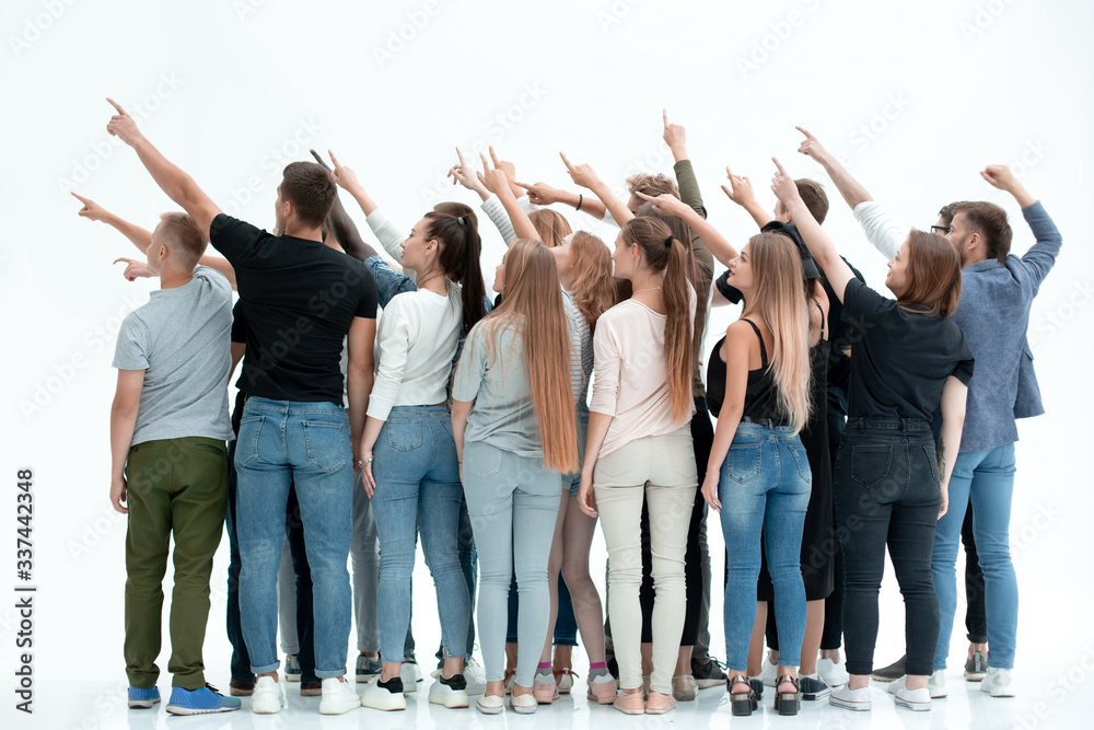 Fototapeta premium rear view.a group of young like-minded people pointing ahead .