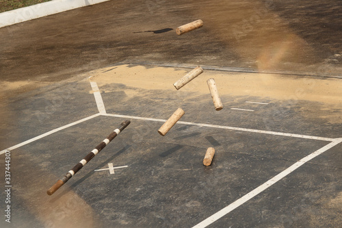 Russian folk game gorodki sport on the pavement. bits and wooden figures. photo