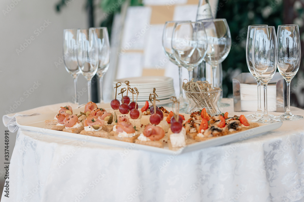 Catering services background with snacks and wine glasses on bartender counter in restaurant