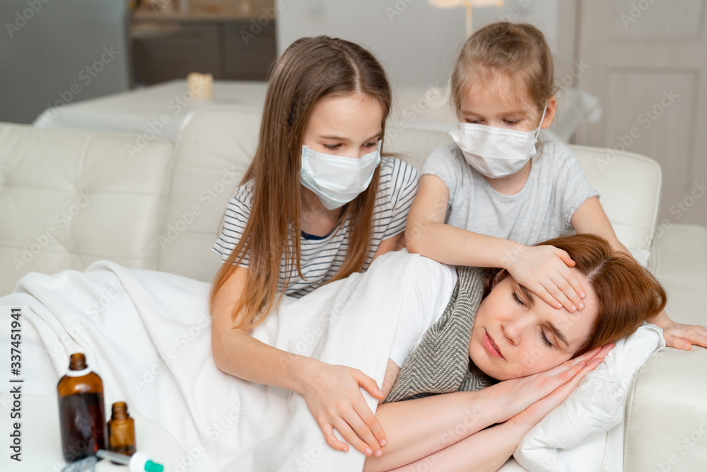kids in masks take temperature of sick mother. kids in masks take temperature of sick mother.