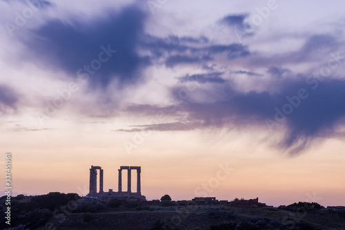 The famous ancient temple of Poseidon in Cape Sounio near Athens Greece during sunset with beautiful cloud formations and pastel colors