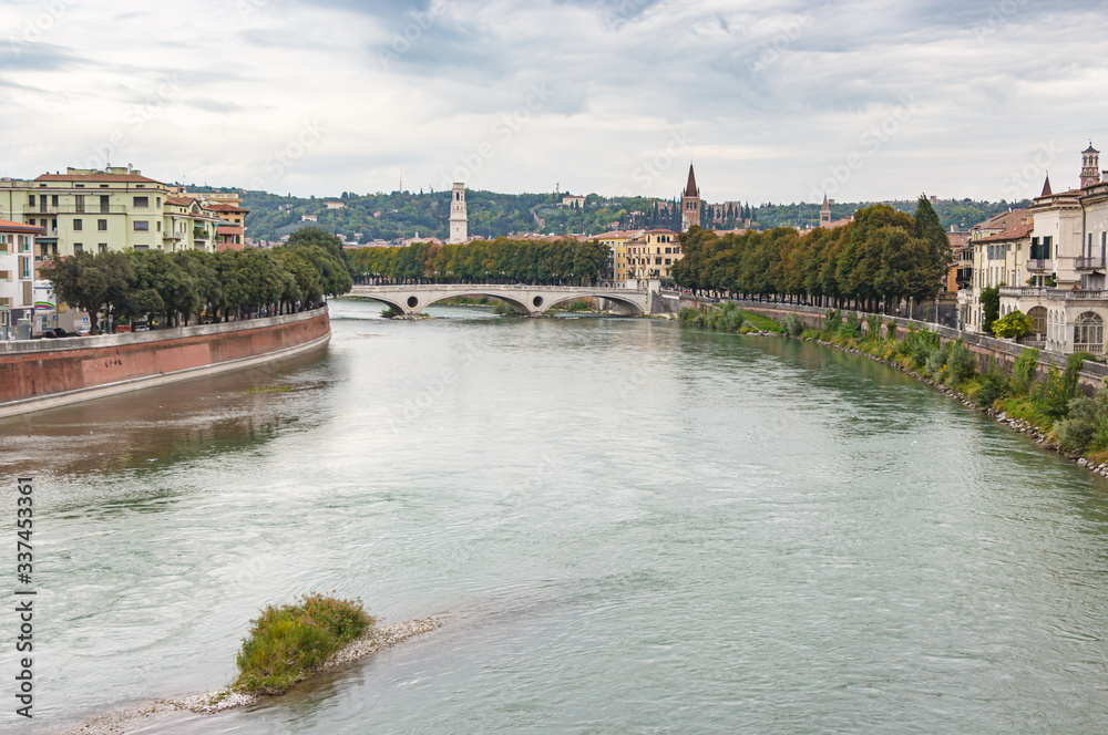 Fototapeta premium View from the Castelvecchio Bridge - Ponte di Castelvecchio of the Adige river, embankments and Verona city in Italy