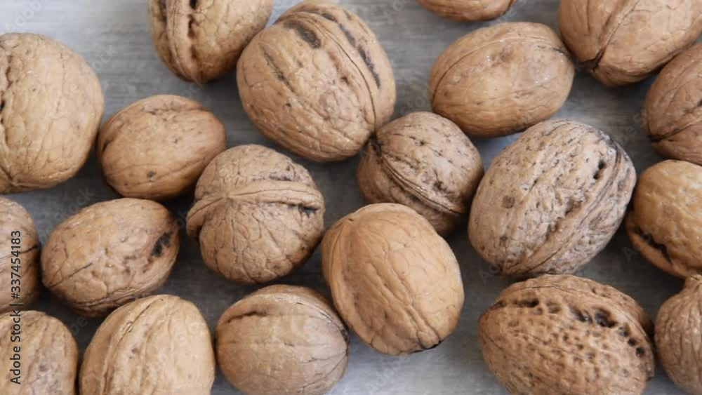 Whole raw walnuts on white background, healthy eating ingredients, vegan and vegetarian food Whole raw walnuts on white background, healthy eating ingredients, vegan and vegetarian food