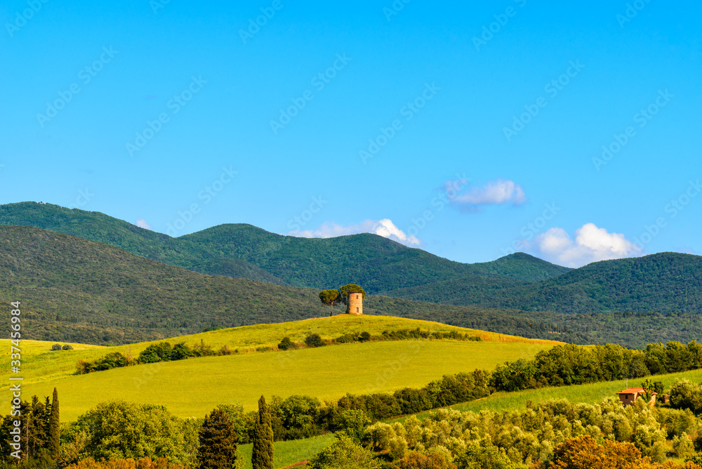 Scenic View Of Field And Mountains Against Blue Sky