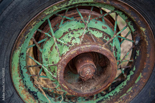 An old spoke wheel hub rusting and losing paint