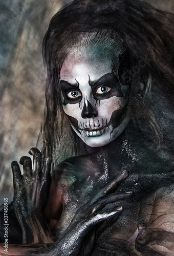 close up portrait of girl with professional Halloween skull makeup. Black veil