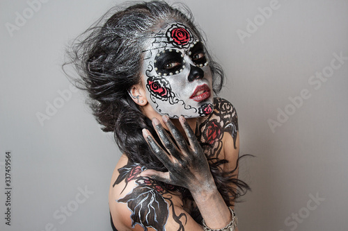 close up portrait of young beautiful girl with professional Halloween makeup. Mexican death photo