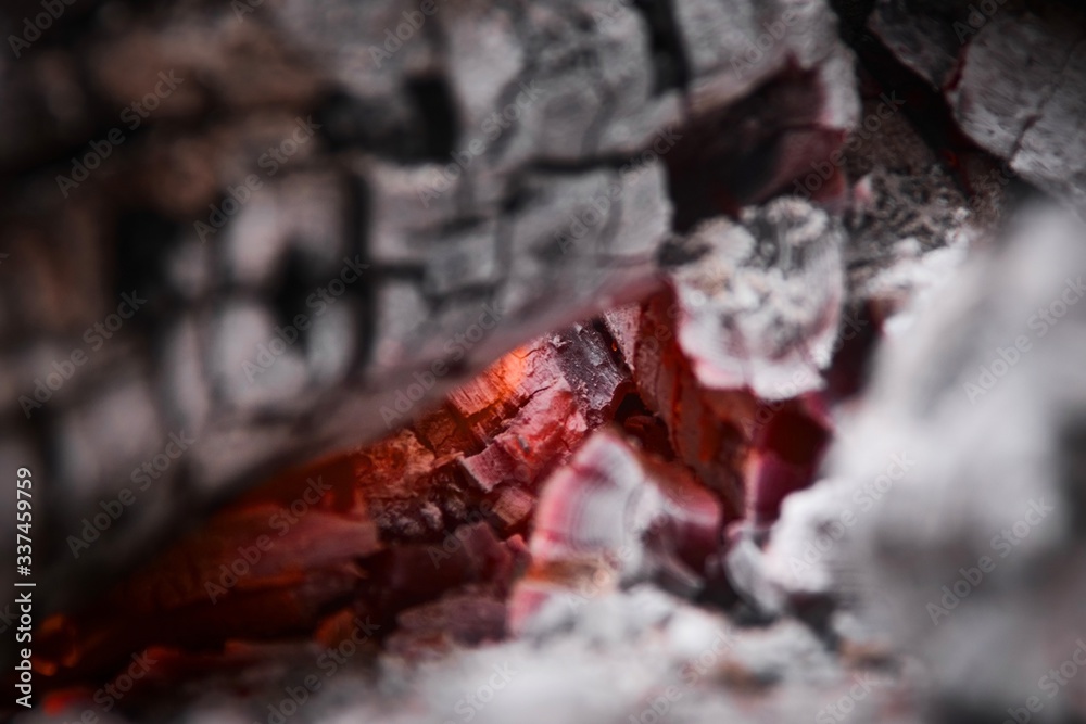 Glowing embers at the heart of a wood fire. Campfire, outdoors, rustic setting. Glowing embers at the heart of a wood fire. Campfire, outdoors, rustic setting.