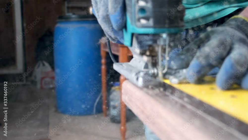 Wood master, makes furniture with a jigsaw slow motion Wood master, makes furniture with a jigsaw slow motion