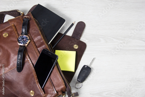 Open men's bag, men's accessories. Space for text. Things fell out of the bag.