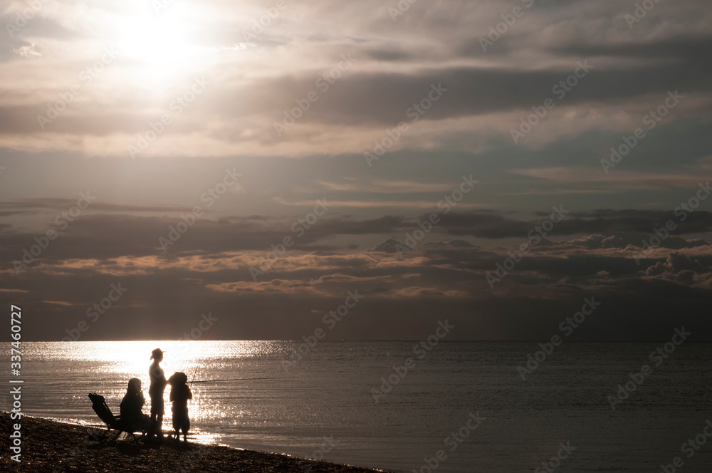 silhouette of a family on the beach