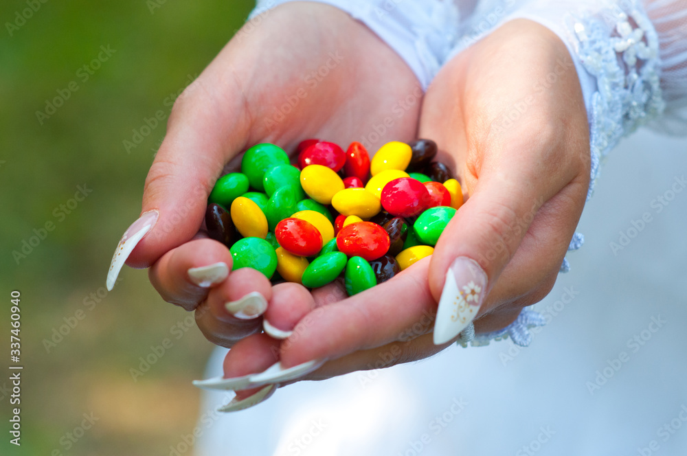 round shaped candy in hands round shaped candy in hands