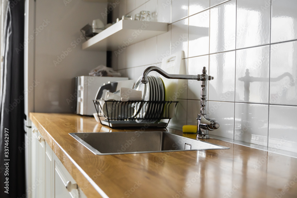Kitchen sink and faucet. Stainless kitchen sink and tap water. The