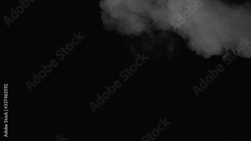 exhales smoke and smoke slowly falls down