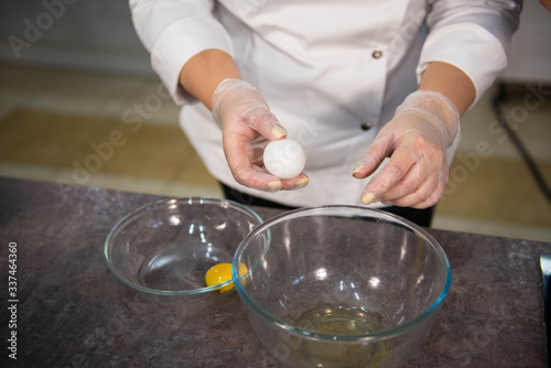 hands preparing eggs for cooking