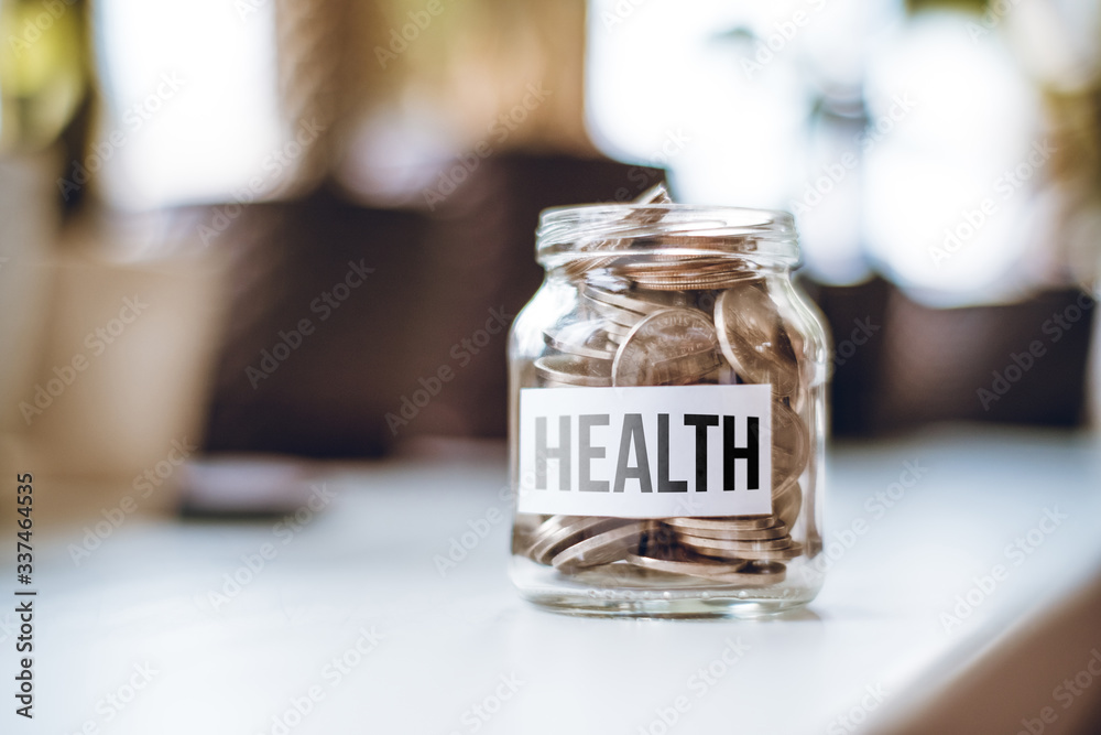 Health money accumulation concept - glass jar with coins.