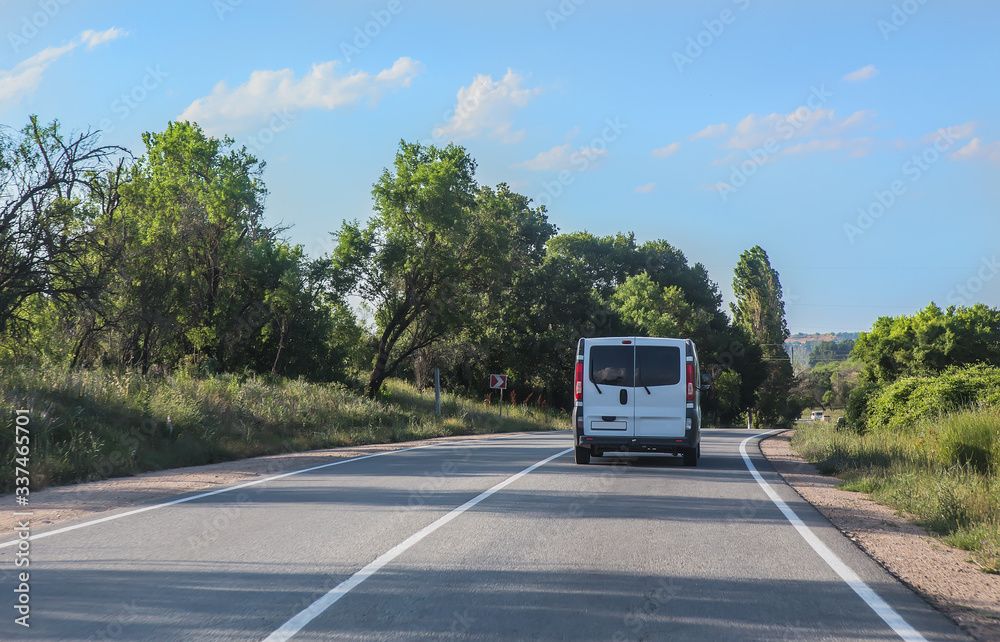 Minivan moves on a suburban highway