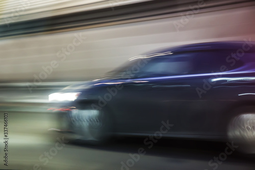 Car rushes along the road in the city. © Yuri Bizgaimer