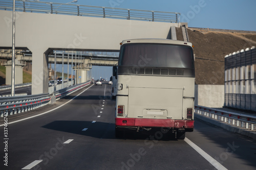 Buses on the highway under railway bridges