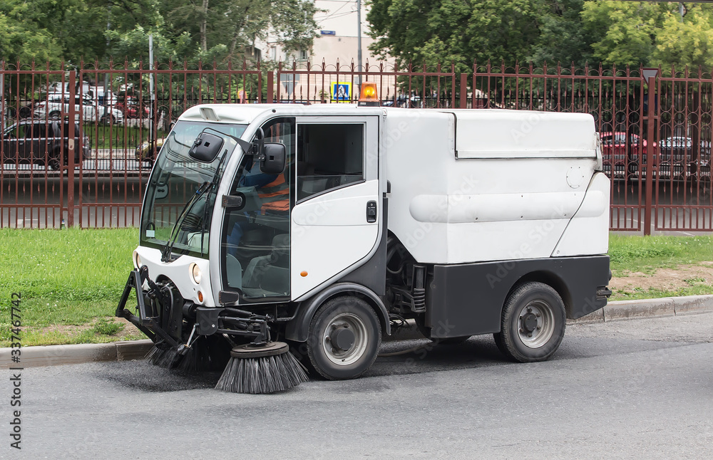 car for cleaning roads with round brushes