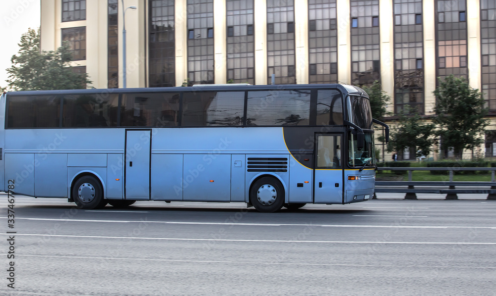 bus moves along a city street