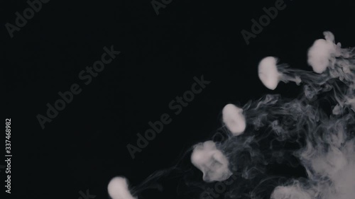 exhales smoke and smoke slowly falls down