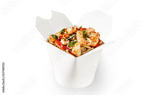 Flavorful shrimp seafood wok noodles with teriyaki sauce. Fresh spring onion, black sesame seeds and red bell pepper on top. Plain white food container for delivery and takeaway branding space 