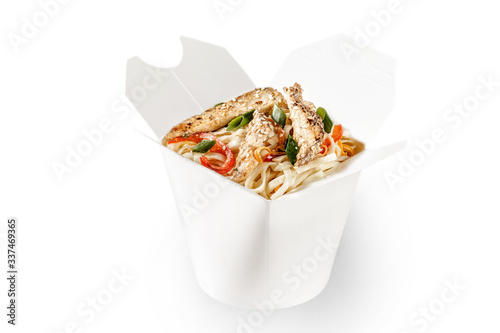 Tasty seafood wok noodle with savory fish, red bell pepper, spring onions and sesame seeds on top. Plain white food container for delivery takeaway text space available for branding.