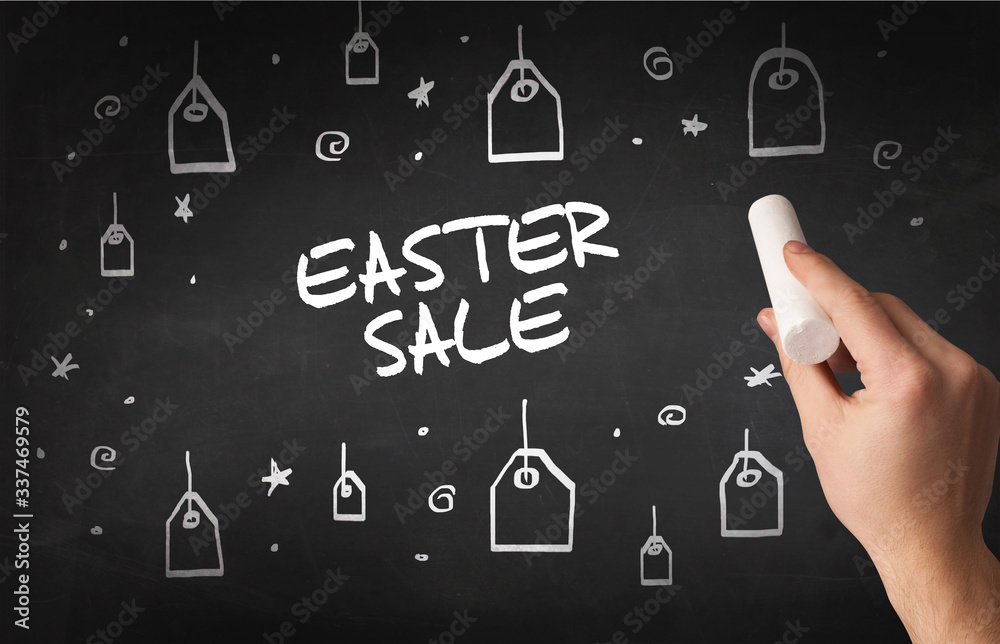 Hand drawing EASTER SALE inscription with white chalk on blackboard, online shopping concept Hand drawing EASTER SALE inscription with white chalk on blackboard, online shopping concept